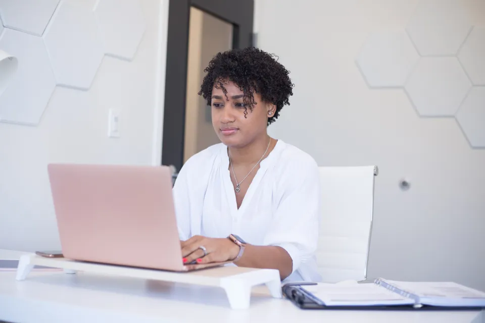 A founder learning on her laptop
