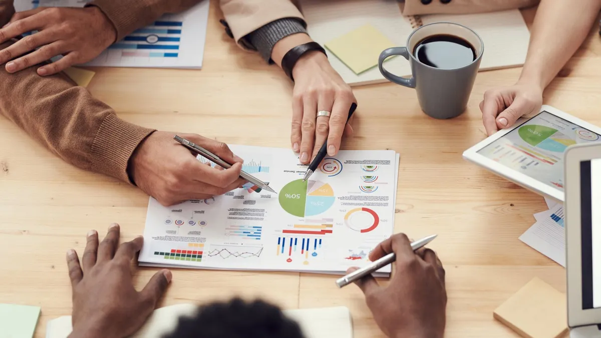 A team reviewing financial charts and documents together